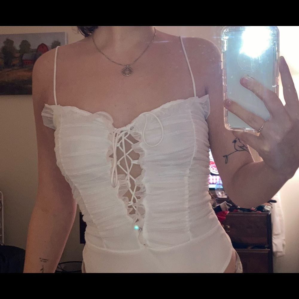 White bodysuit with lace ruffles and tie up front